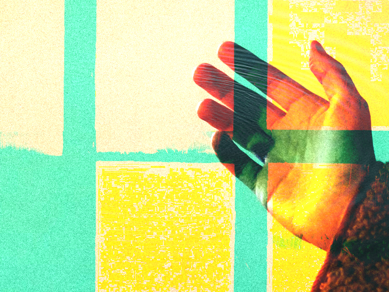 A hand lifted in prayer.